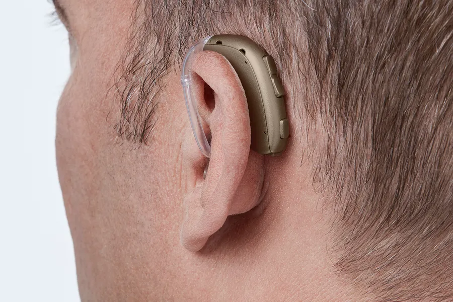 Oticon Xceed BTE SP C094Terracotta AngleB45 Close up In On Ear MS 6930 Man 1200x800px Original file